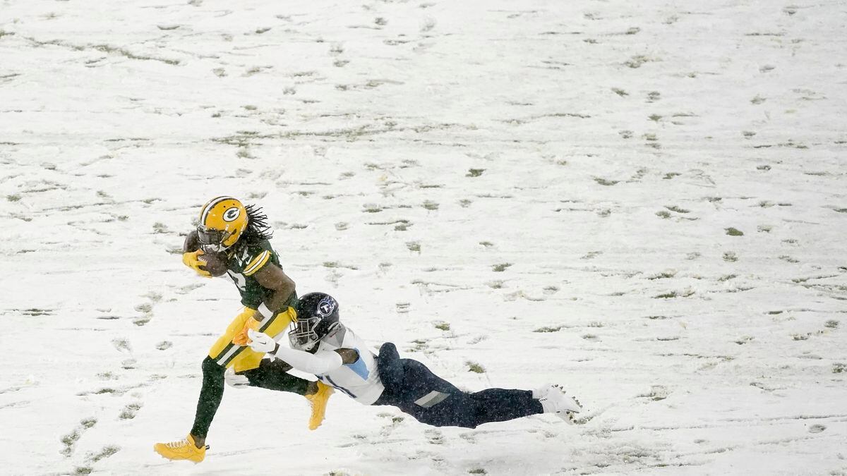 Green Bay Packers' Davante Adams tries to get past Tennessee Titans' David Long during the...