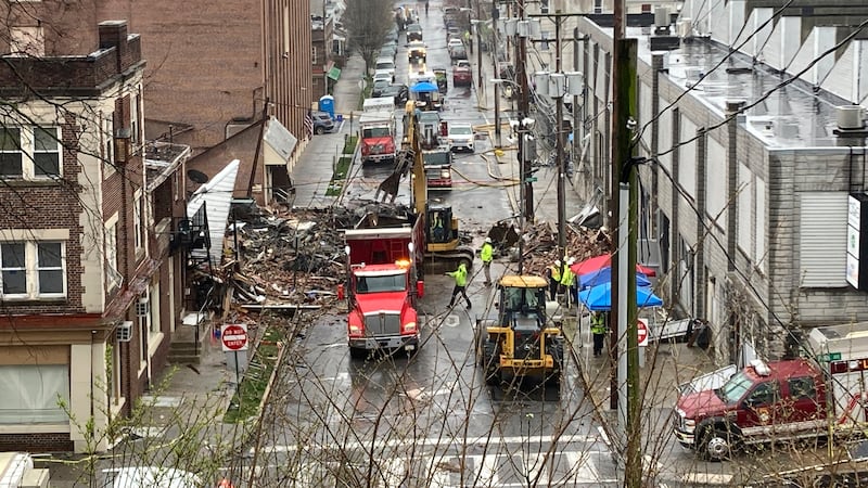 Emergency responders and heavy equipment are seen at the site of a deadly explosion at a...