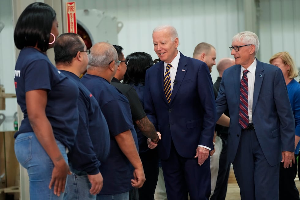 President Joe Biden and Wisconsin Gov. Tony Evers, are greeted by workers as they arrive at...