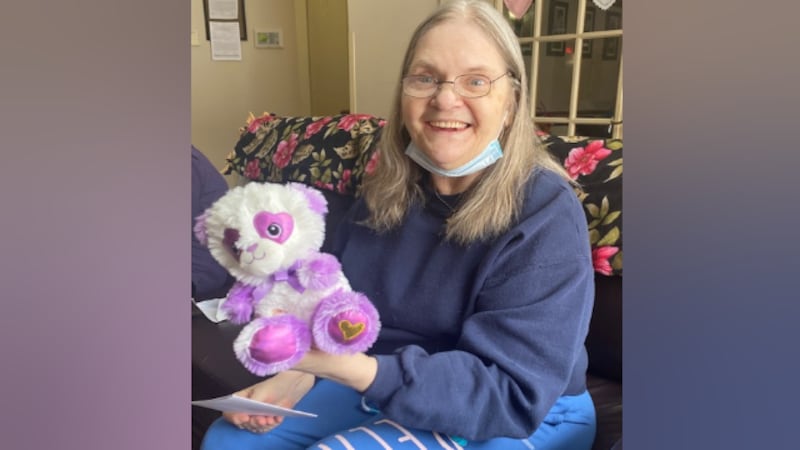Resident Nancy poses with a Valentine's Day bear at Our House Senior Living in Janesville.