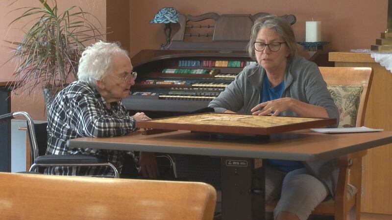 Bernice Laurent plays her first game of Scrabble with her daughter on a new game board she...