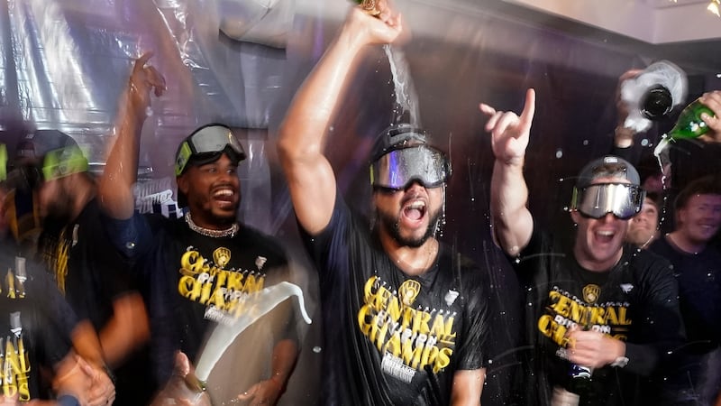 Milwaukee Brewers' Joel Payamps celebrates with teammates after clinching the National League...