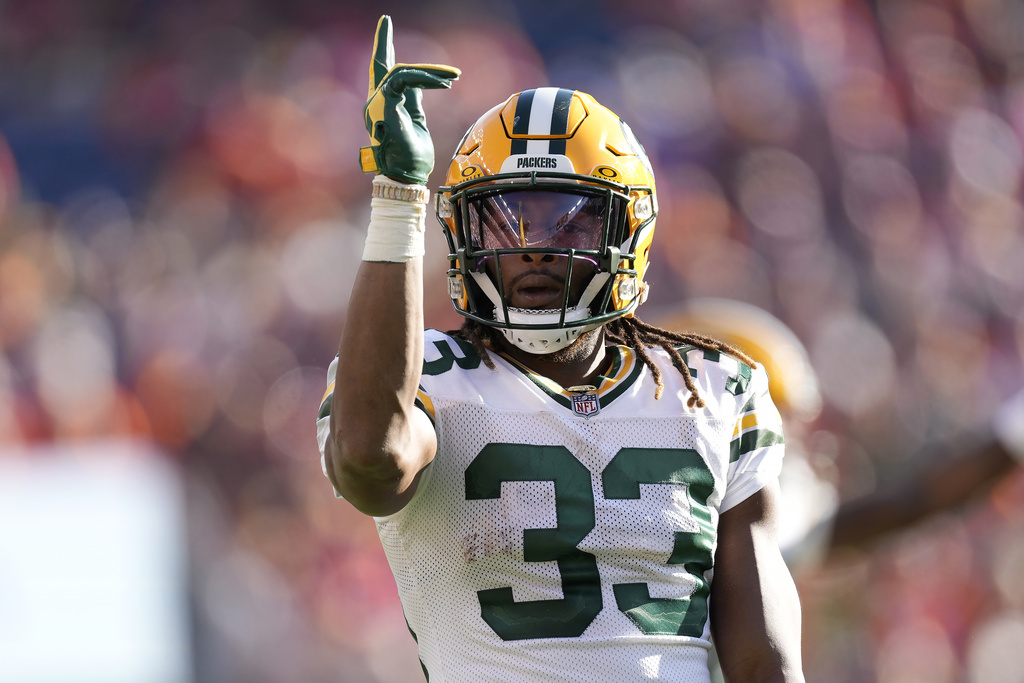 Green Bay Packers running back Aaron Jones (33) signals for a first down during the second...
