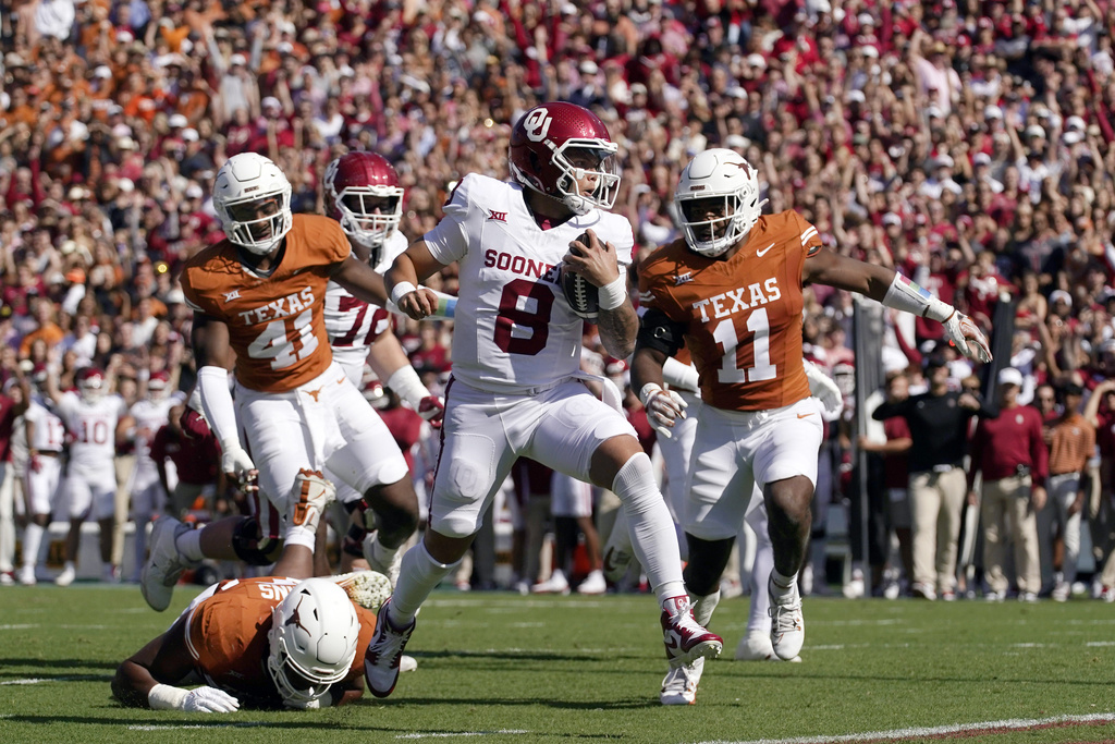 Oklahoma quarterback Dillon Gabriel (8) scores a touchdown ahead of Texas defenders Alfred...