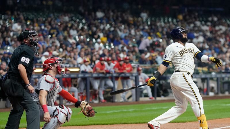 Milwaukee Brewers' Carlos Santana hits and RBI double during the third inning of a baseball...