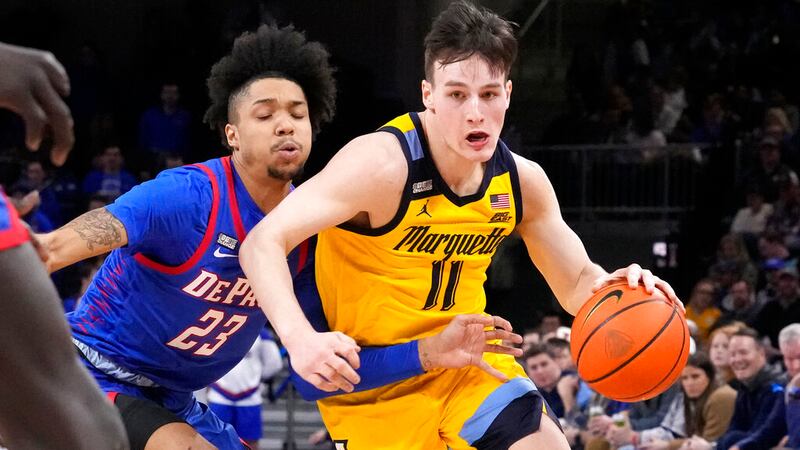 FILE - Marquette's Tyler Kolek (11) drives to the basket as DePaul's Caleb Murphy defends...