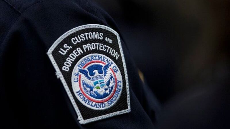 A customs agent wears a patch for the U.S. Customs and Border Protection agency, which is a...